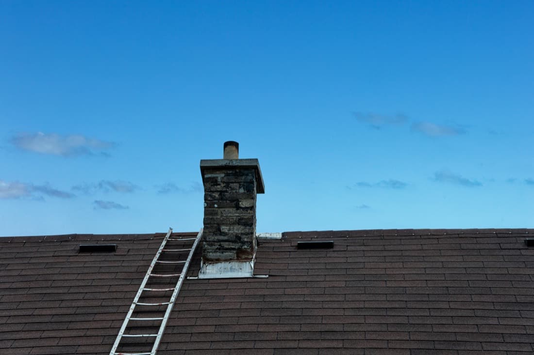 Brick chimney with base flashing on a shingle roof