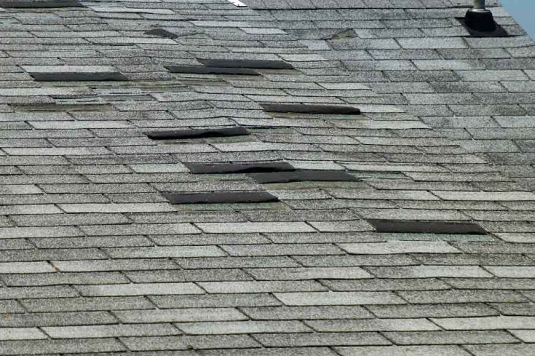 Asphalt-shingle roof with missing and curled tabs